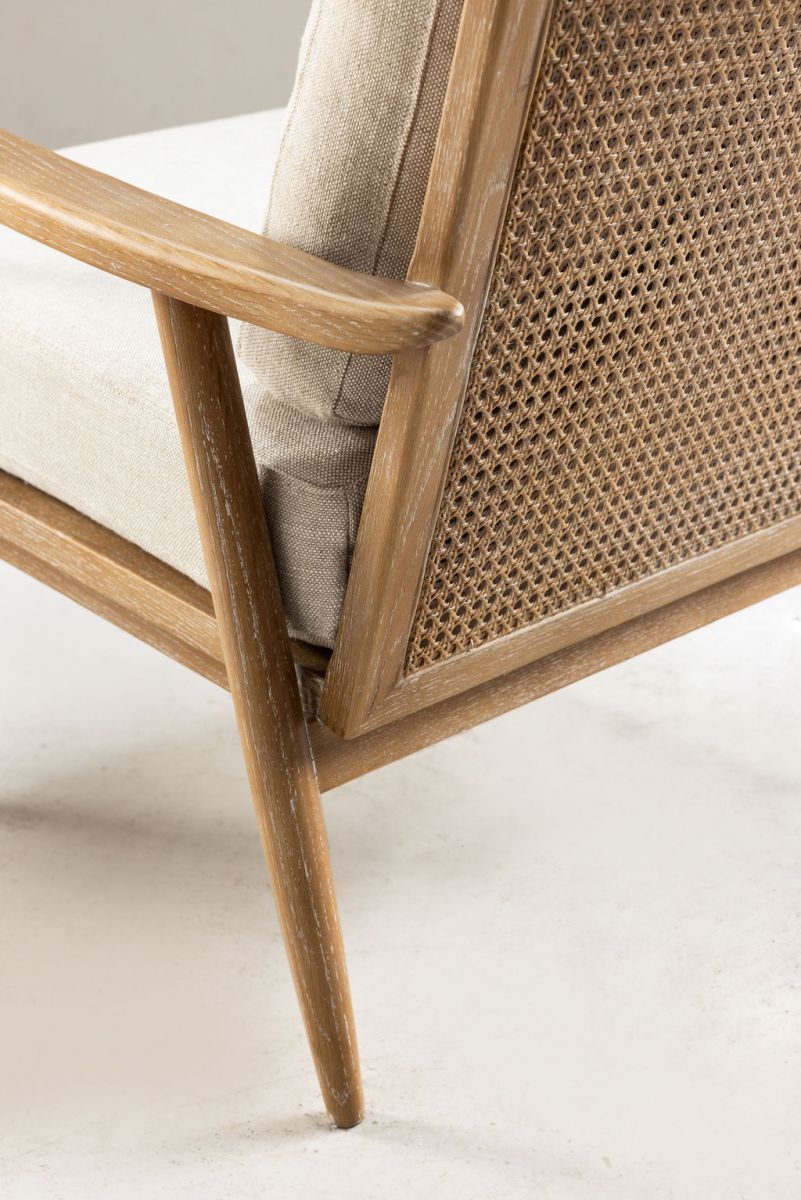 modern armchair with rattan back and linen seat and back cushion