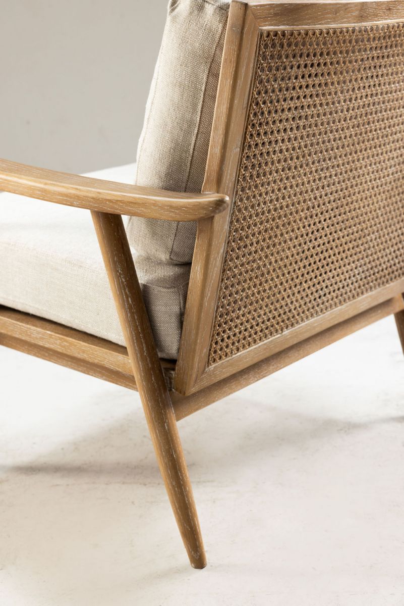 modern armchair with rattan back and linen seat and back cushion