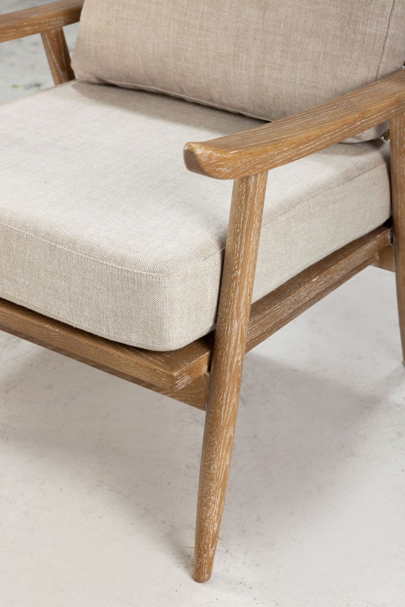 modern armchair with rattan back and linen seat and back cushion