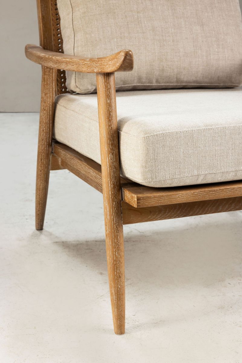 modern armchair with rattan back and linen seat and back cushion