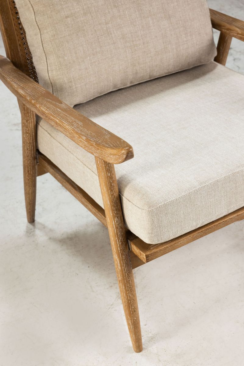 modern armchair with rattan back and linen seat and back cushion