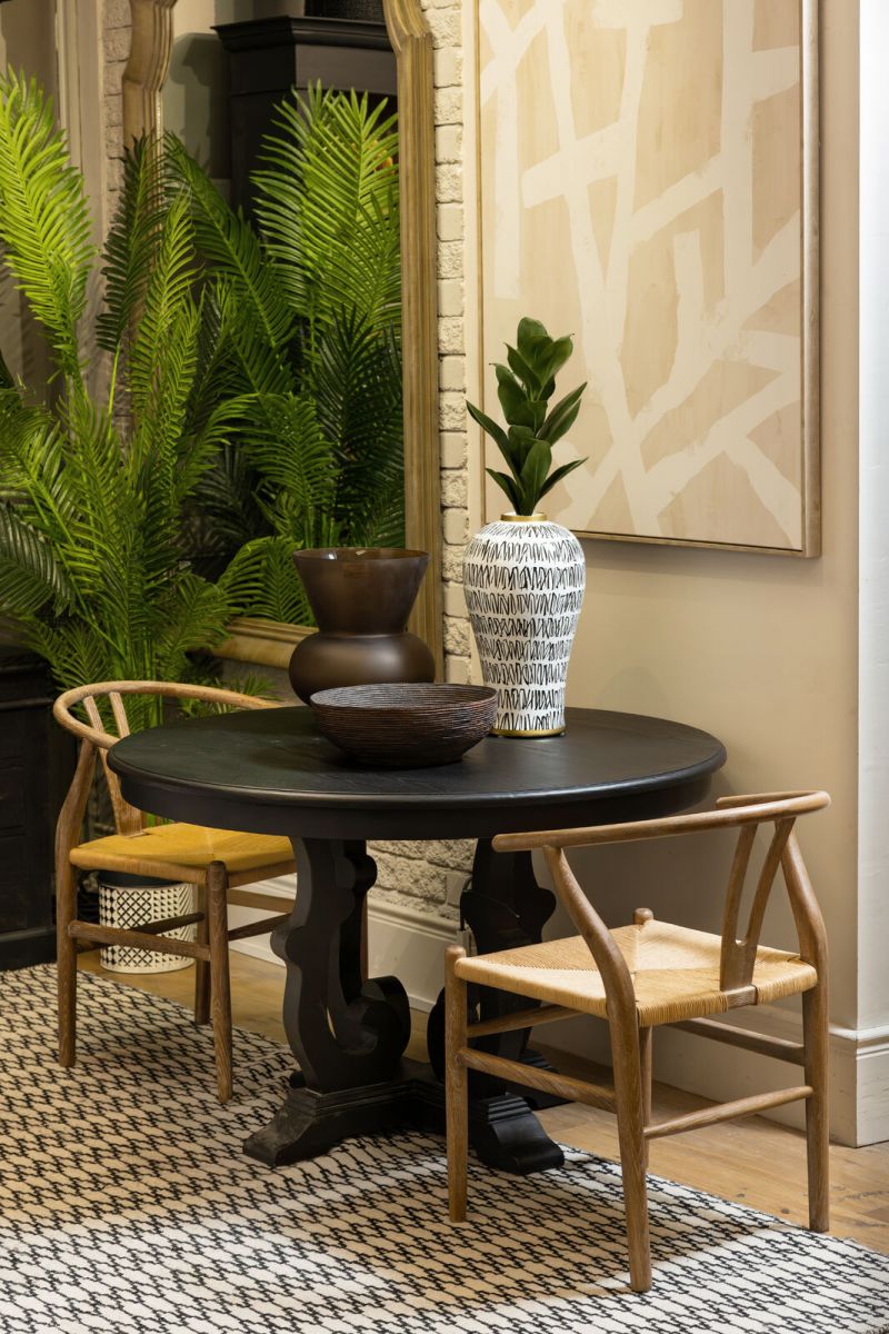 dark wood round dining table with decorative base Château Collection 