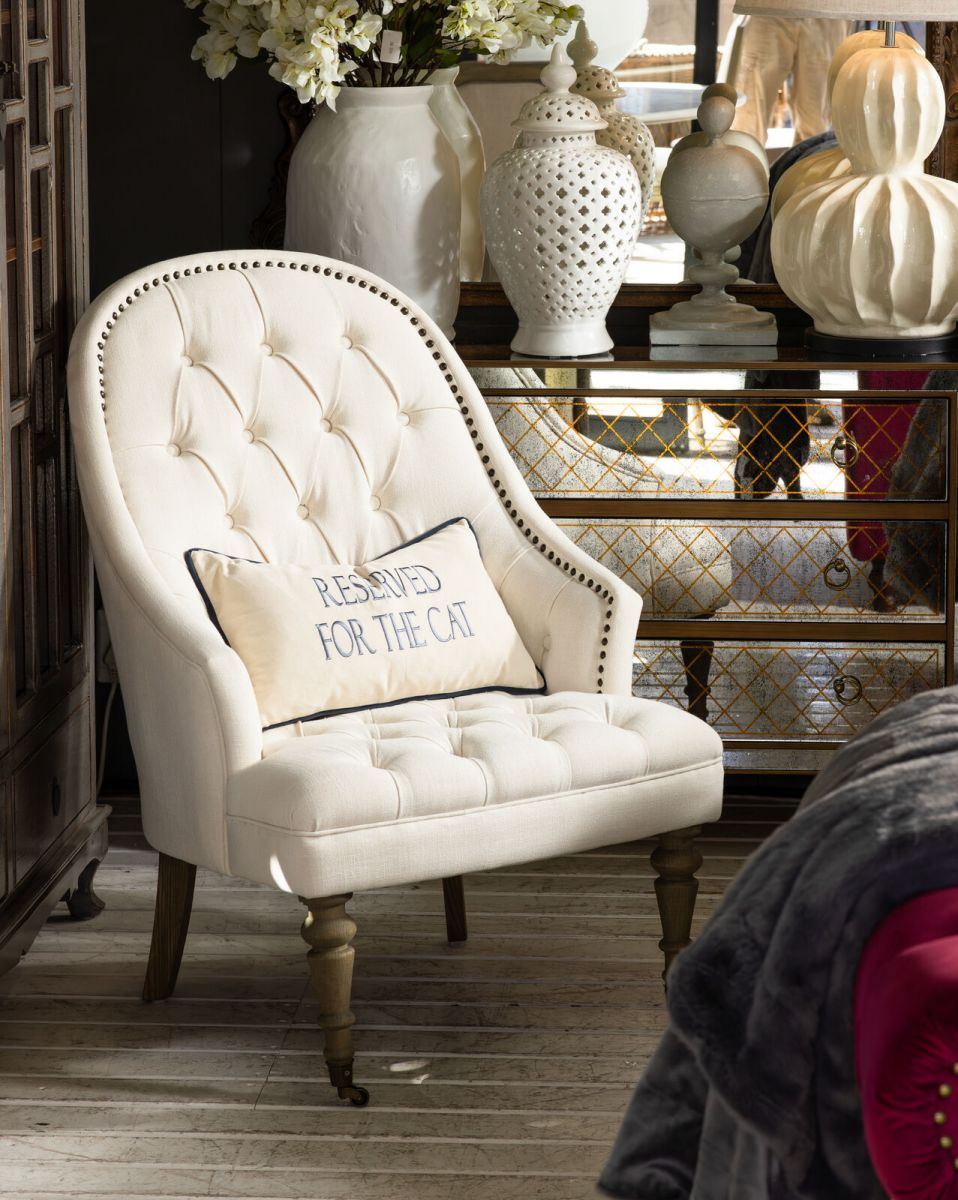 cream upholstered deco chair with deep buttoned detail, oak legs and castors, Château Collection 