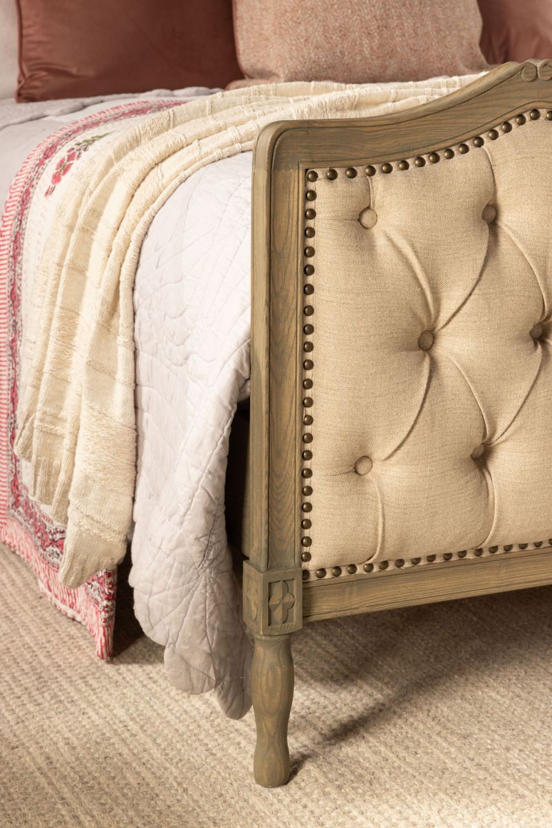 French style bed with deep button detail upholstered in linen