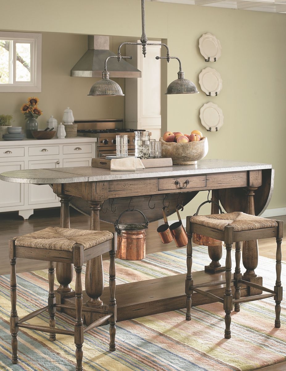 wooden kitchen island with 2 counter chairs