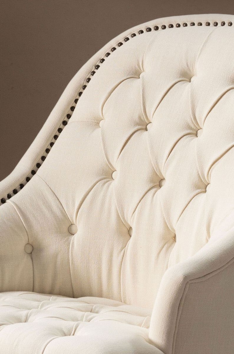 cream upholstered deco chair with deep buttoned detail, oak legs and castors, Château Collection 