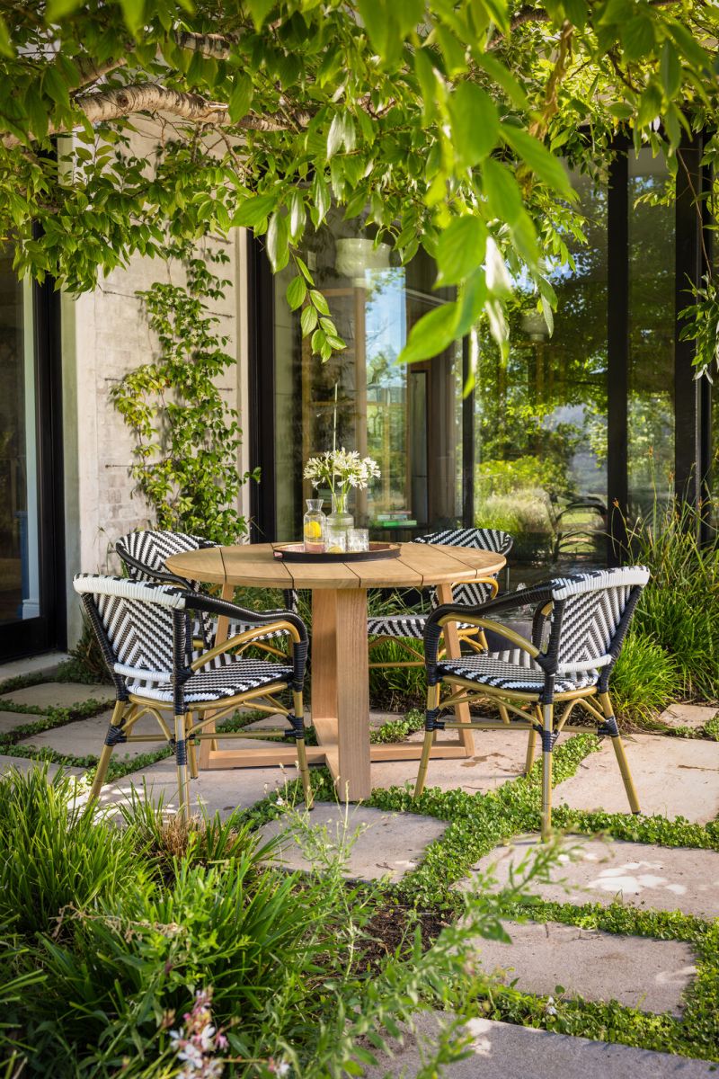 Round outdoor dining table in iroko