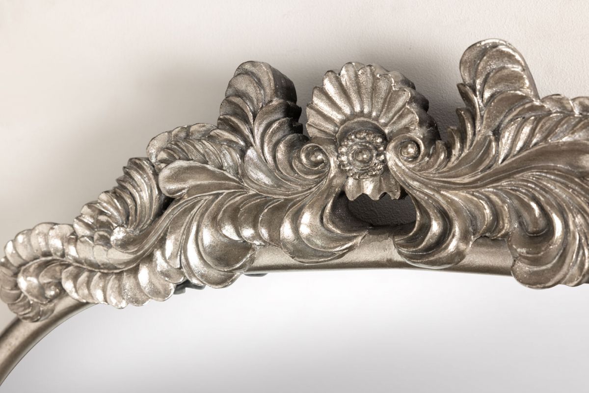 silver framed mirror with ornate top