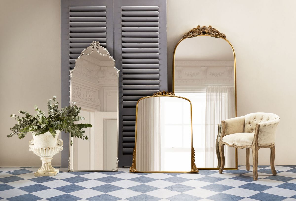 Gold framed mirror with ornate top