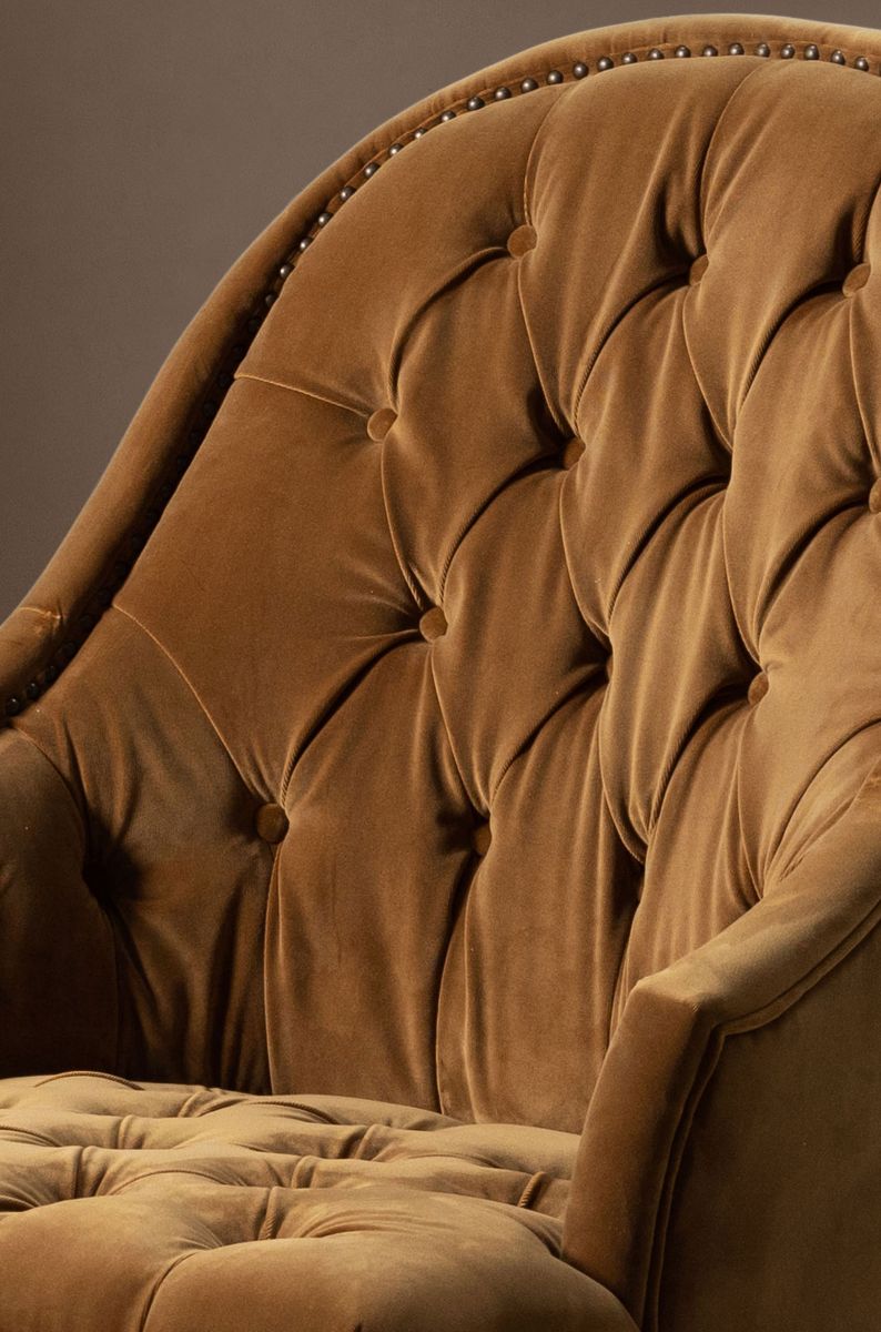 Deco chair upholstered in gold velour with deep buttoned detail, oak legs and castors Château Collection