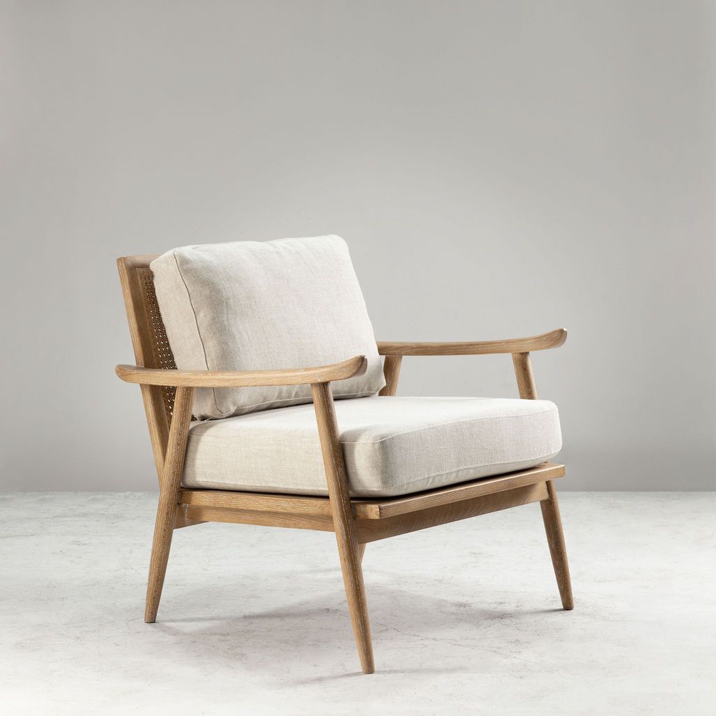 modern armchair with rattan back and linen seat and back cushion