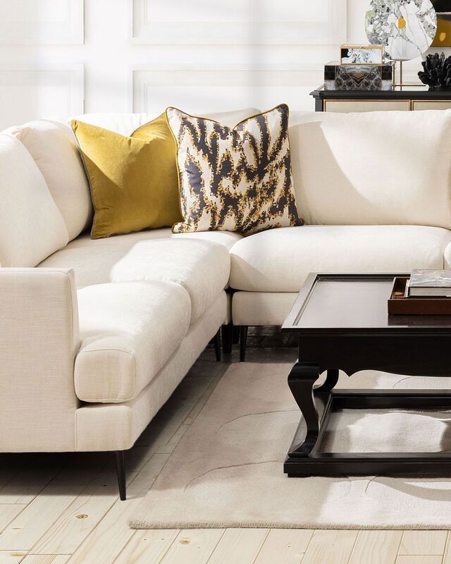 cream modern corner unit with freestanding ottoman