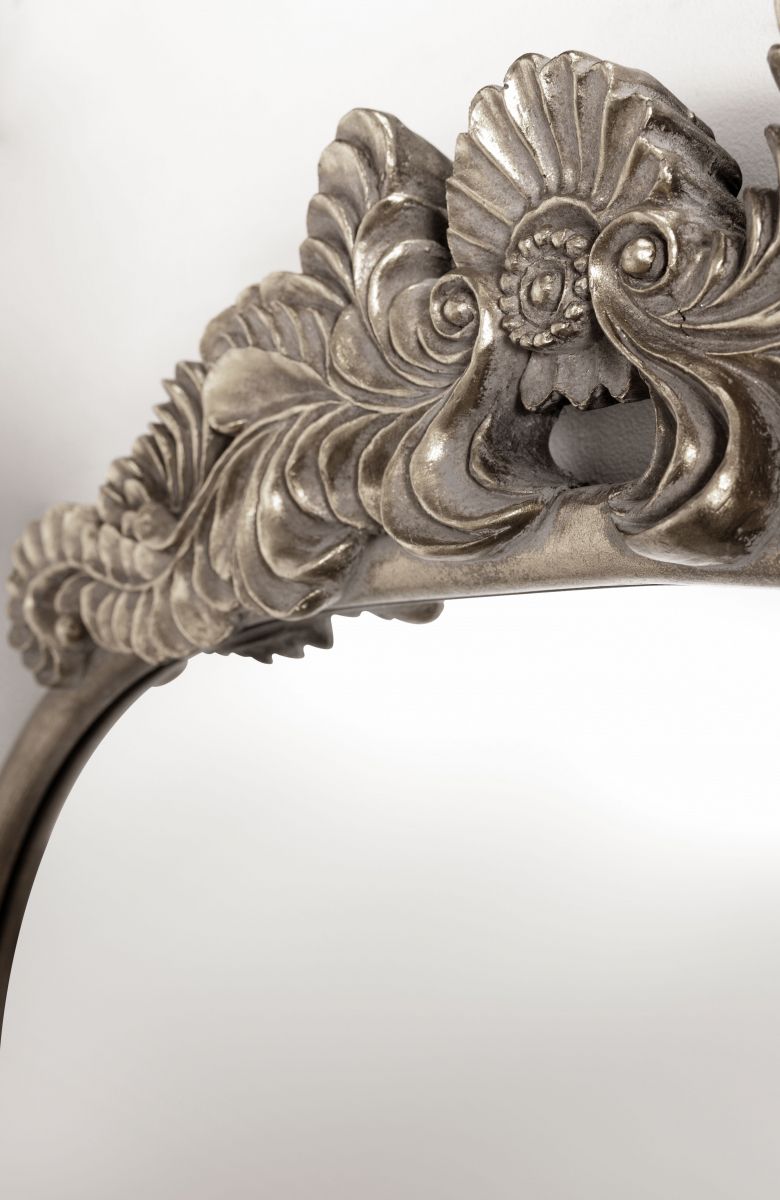 silver framed mirror with ornate top