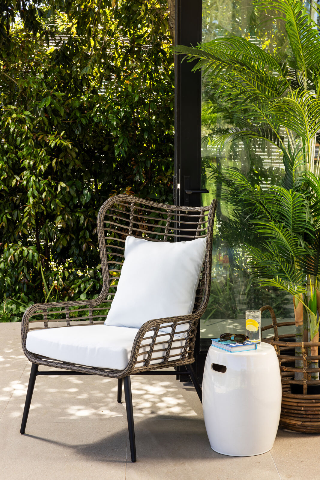 Outdoor accent chair with white cushions 