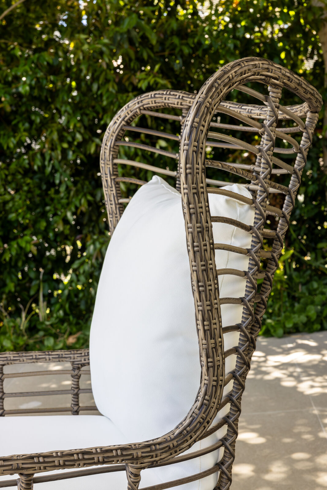 Outdoor accent chair with white cushions 