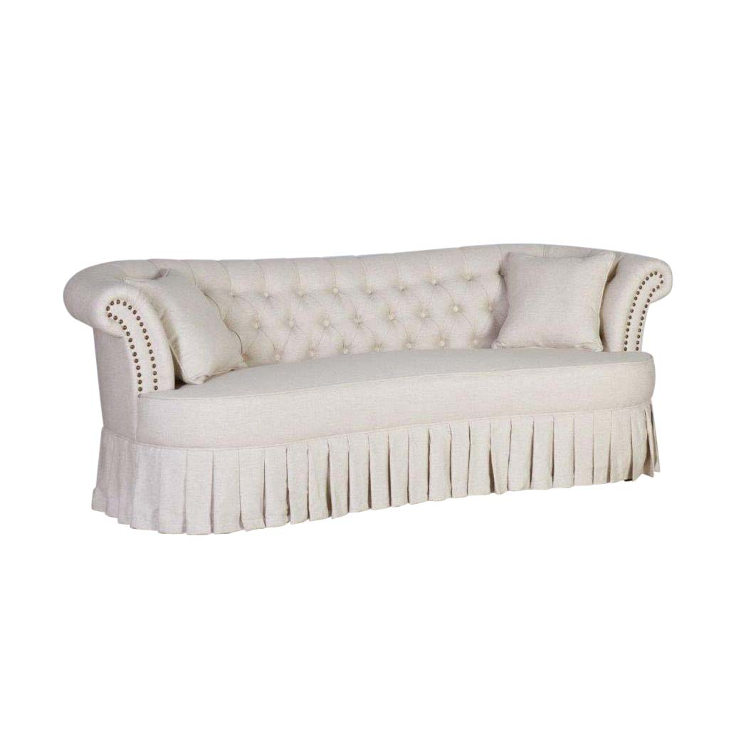 Beige 3 seater sofa with deep buttoned back and pleated skirt detail