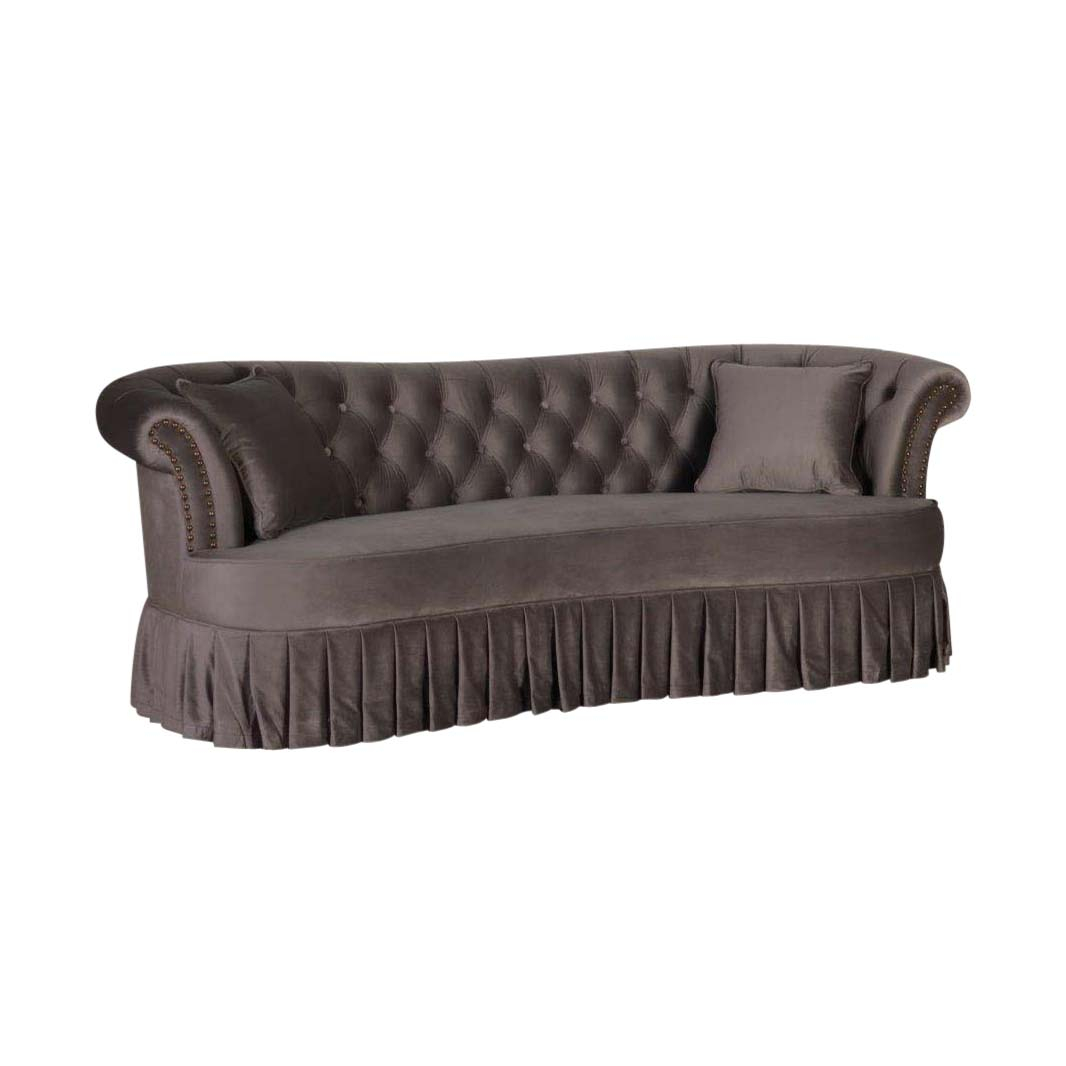 grey velvet french style sofa with deep buttoned back and pleated skirt detai