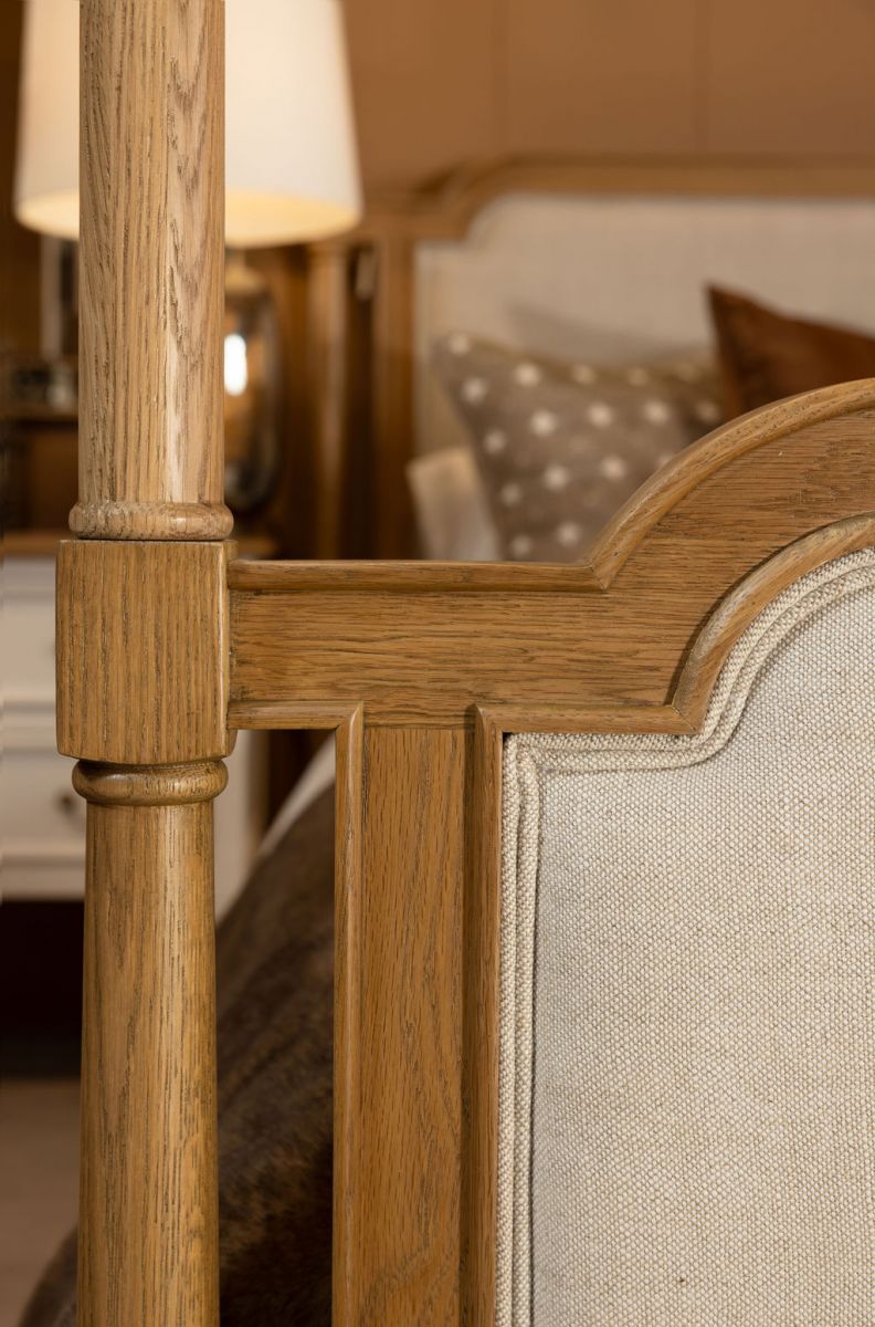 wooden 4 poster bed with fabric headboard and footboard