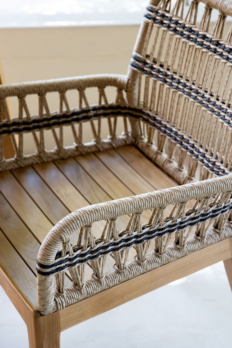 Outdoor dining armchair with teak frame and synthetic rope weave