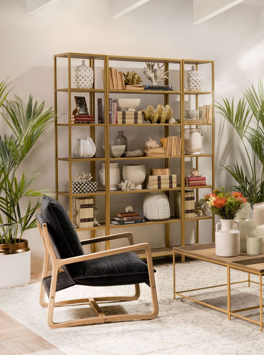 Gold metal bookshelf with wicker inlay shelving